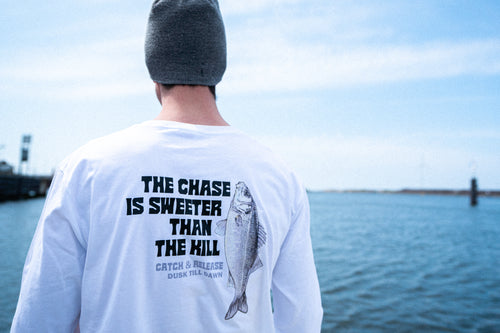 Fishing brand longsleeve white with a seabass print and the adventurous text the chase is sweeter than the kill. Catch and release